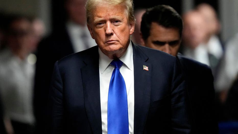 donald trump walking down hall at trial